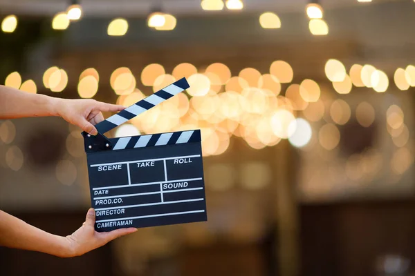 Man hands holding movie clapper. Film director concept. camera show viewfinder image catch motion in interview or broadcast wedding ceremony, catch feeling, woman hand hold a Film Slate over bokeh