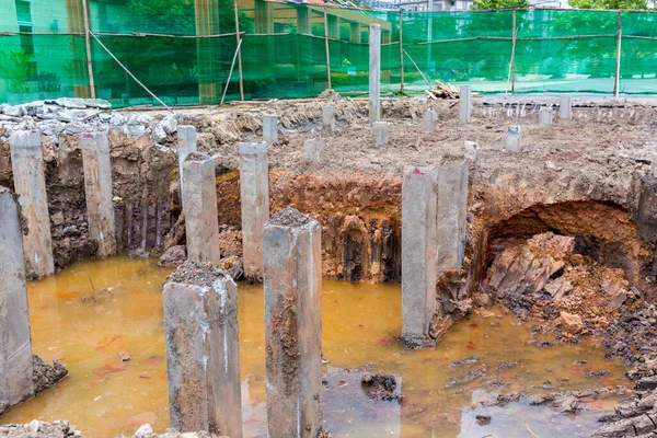 Concrete piles foundation for a new building on construction site. foundation concrete pile under ground for base construction.