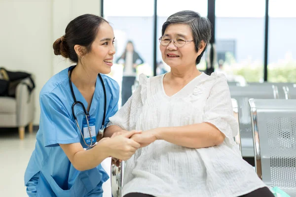 Nurse take care Elderly patient in hospital ward. Elderly woman sit down at hospital. Senior woman at hospital for a check-up