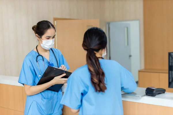 Female doctor stands at hospital. Healthcare worker. woman pharmacist with and stethoscope smiling satisfied with her job in hospital. black health professional wearing stethoscope for support Patient