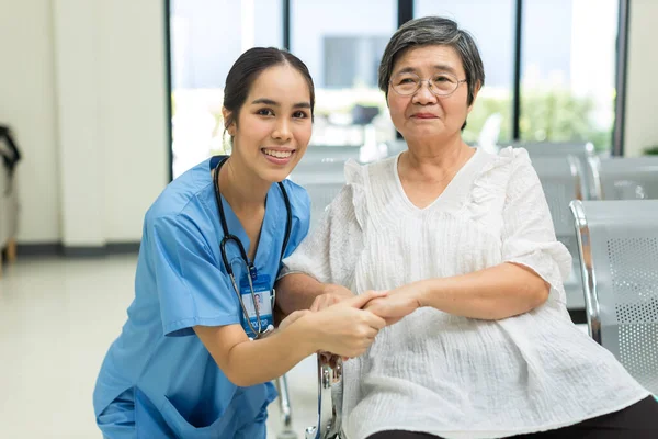 Nurse take care Elderly patient  in hospital ward. Elderly woman sit down at hospital. Senior woman at hospital for a check-up