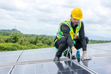 Engineer working setup Solar panel at the roof top. Engineer or worker work on solar panels or solar cells on the roof of business building