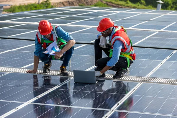 engineer and technology concept with solar panels. Engineer working setup Solar panel at the roof top. Engineer or worker work on solar panels or solar cells on the roof of business building
