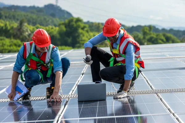 engineer and technology concept with solar panels. Engineer working setup Solar panel at the roof top. Engineer or worker work on solar panels or solar cells on the roof of business building