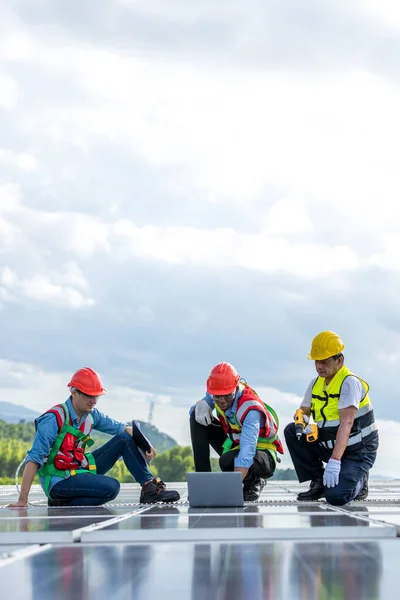 engineer and technology concept with solar panels. Engineer working setup Solar panel at the roof top. Engineer or worker work on solar panels or solar cells on the roof of business building