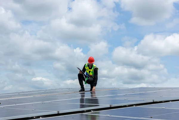 Engineer working setup Solar panel at the roof top. Engineer or worker work on solar panels or solar cells on the roof of business building