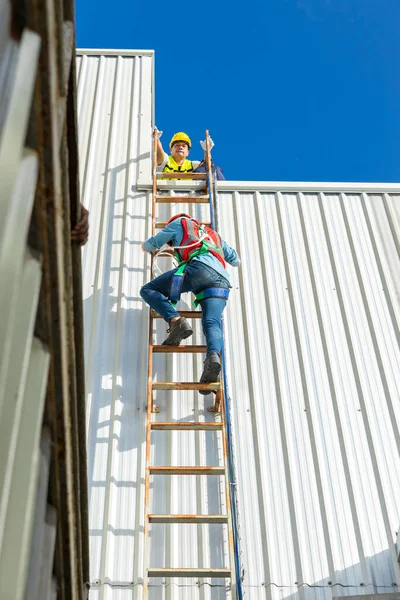 Engineering or worker descended the fire escape to the safe zone. Man in Fire escape to the roof. Worker climbing down fire escape ladder