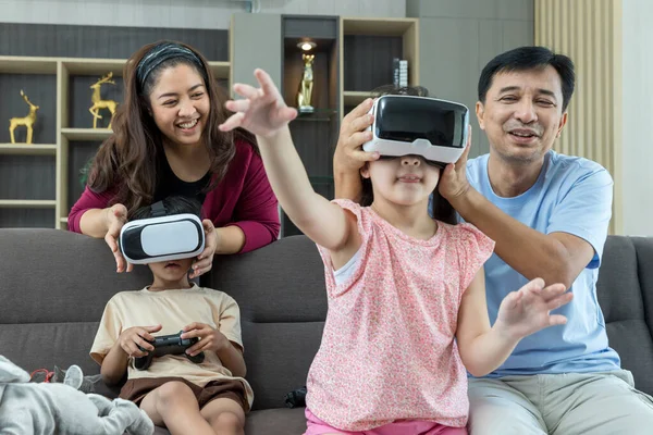 Daughter and Son using VR glasses at home for gaming or learning. Family activities concept. VR glasses family activity