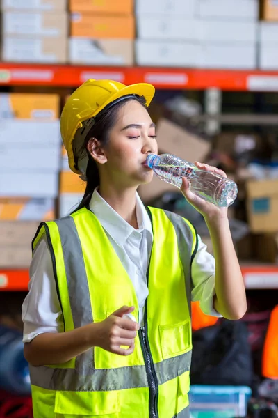 Young Woman Protective Uniform Yellow Vest Drinking Water Bottle While — Stockfoto