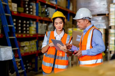Team Foreman or Team worker working in warehouse. Industrial and industrial workers concept. worker woman order details and checking goods and Supplies.