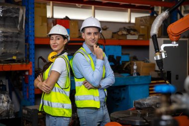 Engineer or Worker in intelligent factory industrial. Engineer check and control automation robot arms machine in intelligent factory industrial