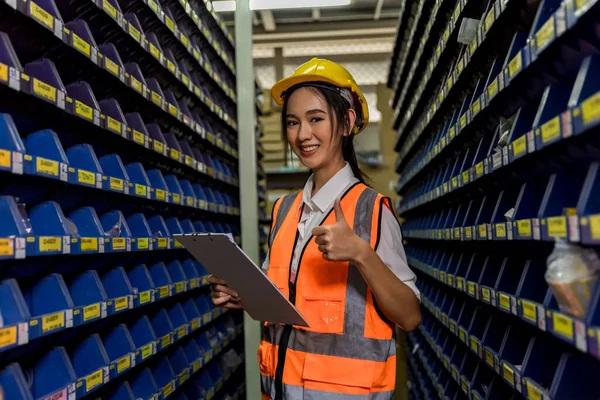 Woman worker working in warehouse. Industrial and industrial workers concept. worker woman order details and checking goods and Supplies.