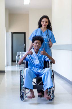 Patients sitting on wheelchairs. Man patient in a wheelchair and nurse support at hospital.