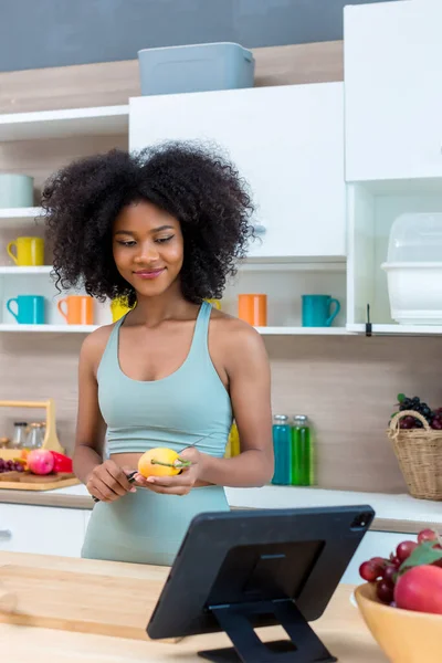 woman using the tablet in kitchen at home