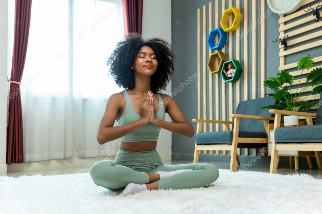 Woman doing yoga at home in the living room. Woman is stretching in yoga at home. work out time
