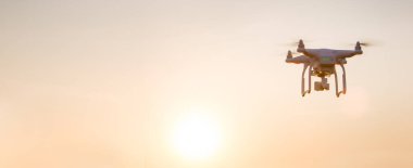 Drone copter flying with digital camera. Drone with high resolution digital camera. Flying camera take a photo and video. The drone with professional camera takes pictures 