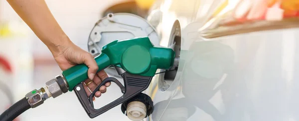 Hand Man Refill and filling Oil Gas Fuel at station. Gas station - refueling. To fill the machine with fuel. Car fill with gasoline at a gas station. Gas station pump.