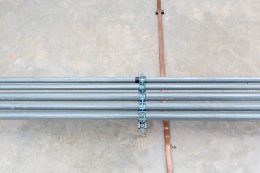 Installation of pipes, wires, electrical work in the building. Electrical conduits system and metal pipeline installed on building.