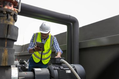 Industrial engineer work on site. engineer visit and inspection site engineer at industrial site. Inspector engineer check and working on site