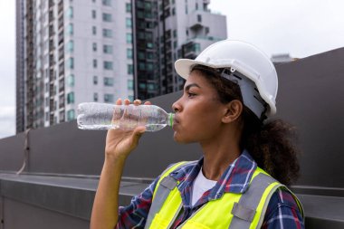 Industrial engineer or Worker drinking water in factory site.
