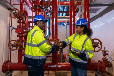 Engineer or technician work checking Fire suppression system and fire equipment. Engineer check red generator pump for water sprinkler piping and fire alarm control system