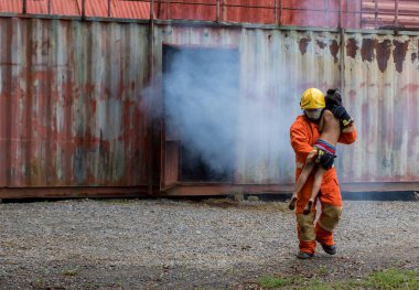 Firefighter to save girl in fire and smoke. Rescue Team or Firefighters save lives people from fire. Firefighter or Emergency team  rescue saving life people from fire