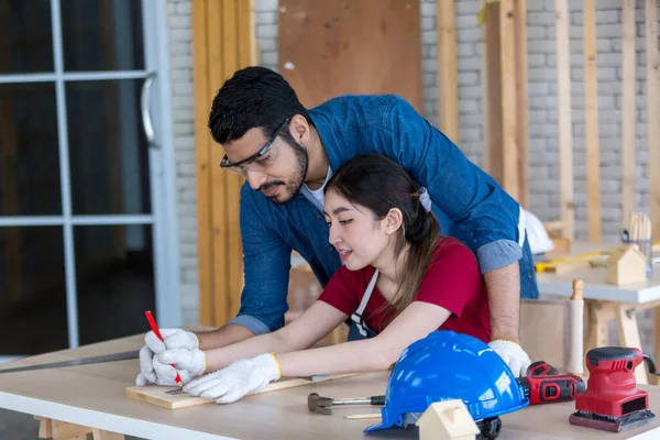 Carpenter working in carpentry shop. Carpenter working to making wood furniture in wood workshop