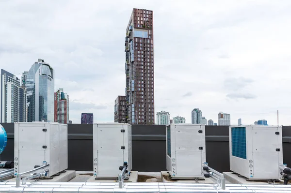 Air conditioner compressor installed on roof building. Industrial air conditioning units. Industrial air conditioning and ventilation systems on roof. Cooling towers in data center building.