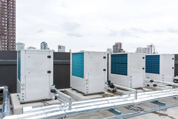 Air conditioner compressor installed on roof building. Industrial air conditioning units. Industrial air conditioning and ventilation systems on roof. Cooling towers in data center building.