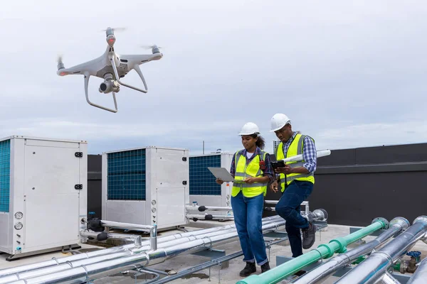 Industrial engineer use drone work on site . engineer visit and inspection site engineer progress by drone fly at industrial site. Inspector engineer check and working on site