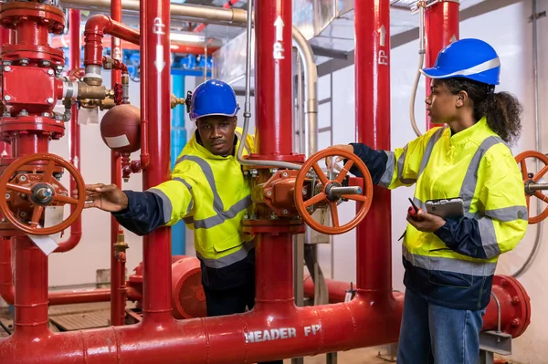 Engineer or technician work checking Fire suppression system and fire equipment. Engineer check red generator pump for water sprinkler piping and fire alarm control system