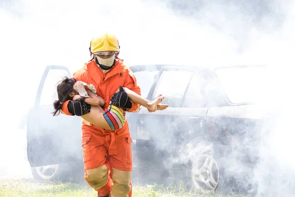 Firefighter to save girl in fire and smoke. Rescue Team or Firefighters save lives people from fire. Firefighter or Emergency team  rescue saving life people from fire