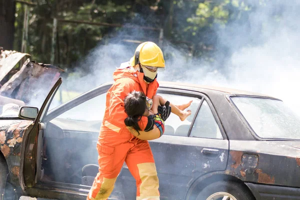 Firefighter to save girl in fire and smoke. Rescue Team or Firefighters save lives people from fire. Firefighter or Emergency team  rescue saving life people from fire