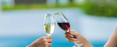 Cheers! People cheering with champagne . Wine Glasses Hitting Together at outdoor. Friend clinking glasses with champagne