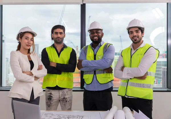 Team Engineers with draft plan of building on constructing site. Engineer work on site. engineer visit and inspection site engineer. Inspector engineer check and working on site.