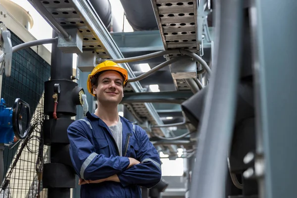 Industrial engineer standing  cross one\'s arm on site. engineer at industrial site. Inspector engineer check and working on site.