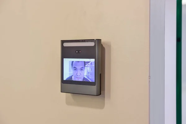 Face scanner machine detect man face to unlock door in office building. Access control facial recognition system. Biometric admittance control device for security system.