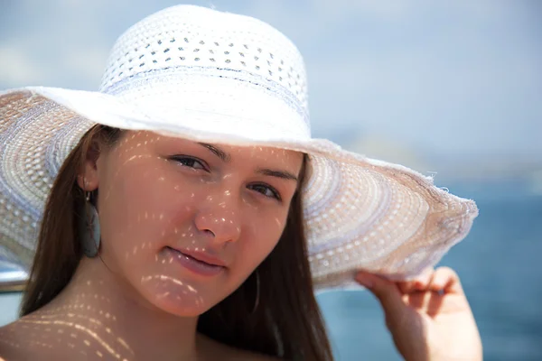 Young beautiful girl in a white hat — Stock Photo, Image