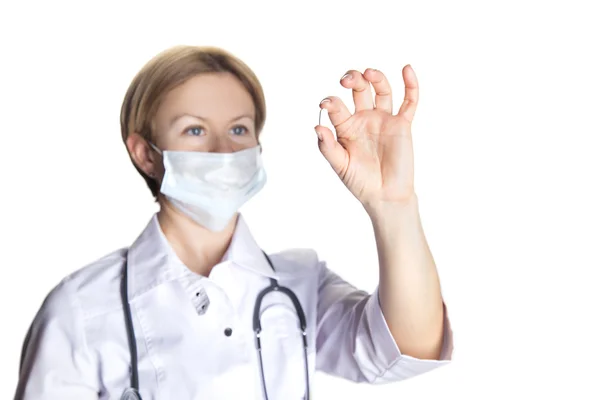 Woman doctor looking at pill — Stock Photo, Image