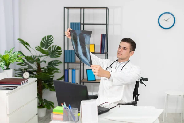 У госпітальному кабінеті лікар-пульмонолог перевіряє рентген пацієнтів . — стокове фото