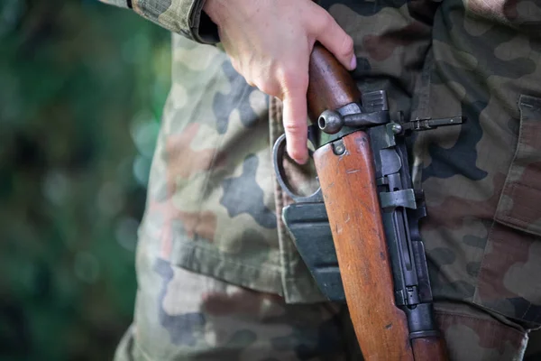 Una soldado inspecciona un rifle recién recibido. Una vista de cerca. — Foto de Stock