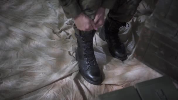 W koszarach wojskowych żołnierz zawiązuje buty. Porządek i porządek w każdym calu. — Wideo stockowe
