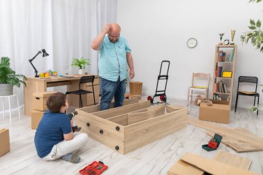 Babam bundan sonra ne yapacağını merak ediyor ve kafasını kaşıyor. Mobilya montajı.