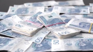 Bandajla tutturulmuş banknot dosyaları. Masaya saçılmış para.