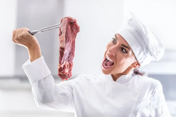 Female Chef Rondon Pretends Wanting Bite Raw Cut Red Steak Royalty Free Stock Photos