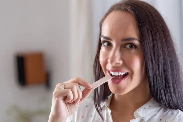 Good Looking Brunette Puts Chewing Gum Her Mouth Looking Camera — Stock Photo, Image