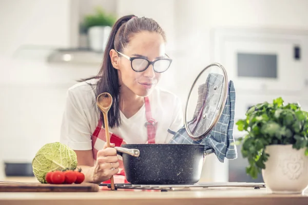 Woman Holding Spoon Lid Cooking Home Opening Saucepan Fogs Her —  Fotos de Stock