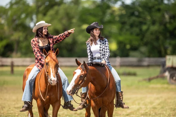 Two Cowgirls Patroling Ranch Ride Horses One Pointing Horizon — Stock Photo, Image