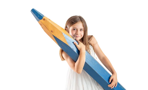 Cute Little Girl Great Effort Holds Huge Blue Pencil Her — Stockfoto