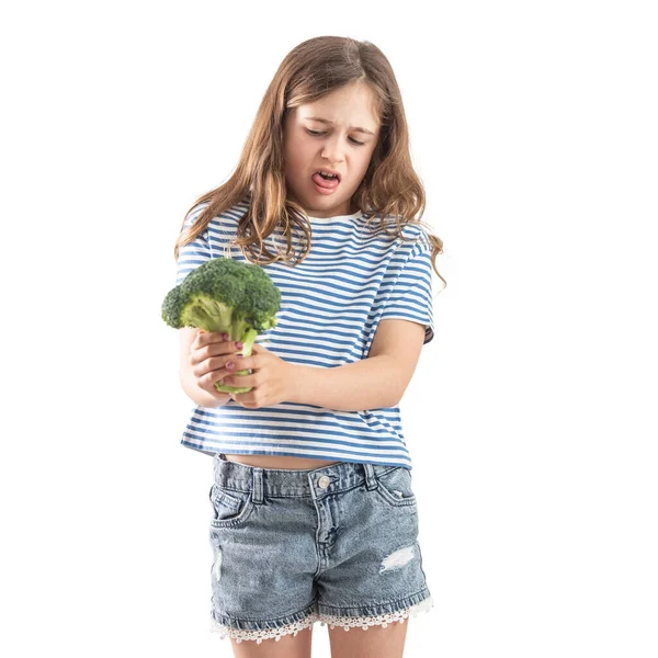 Little Girl Holds Raw Broccoli Her Hand Looks Distaste Isolated — Foto de Stock